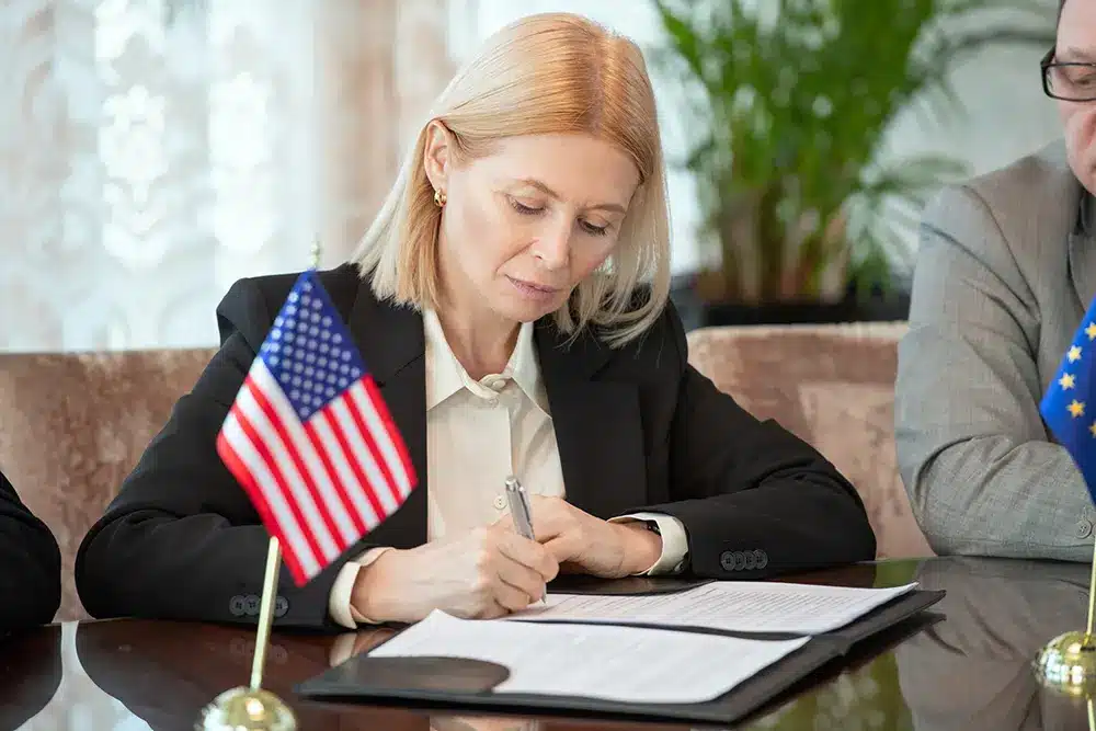 mature-american-delegate-in-formalwear-signing Sponsoring an Employee